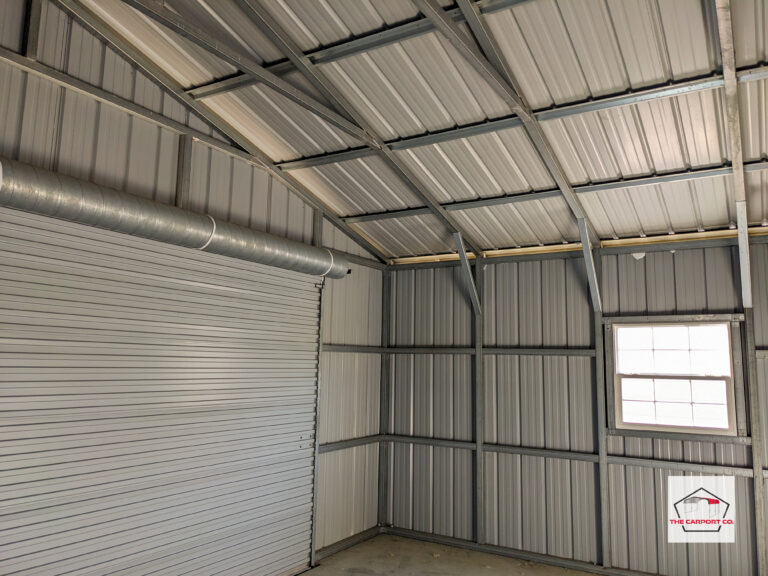 Metal garage interior with vertical siding, vertical roof, roll up door and window. Metal garages are really just enclosed carports.