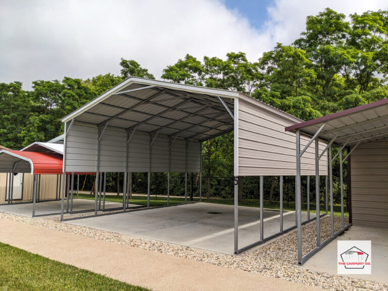 Corner of metal semi, RV, or large truck carport with vertical roof and 6’ of sides. The structure is all white. The measurement of the metal camper carport are roughly 24 feet wide x 20 feet long by 13 feet high.