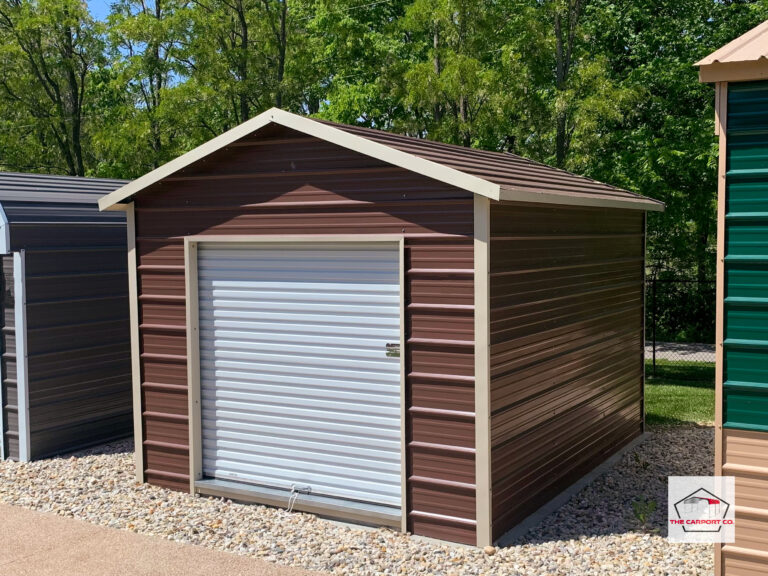 Corner of metal shed with brown siding and tan trim with 6x6 roll up door on front end.