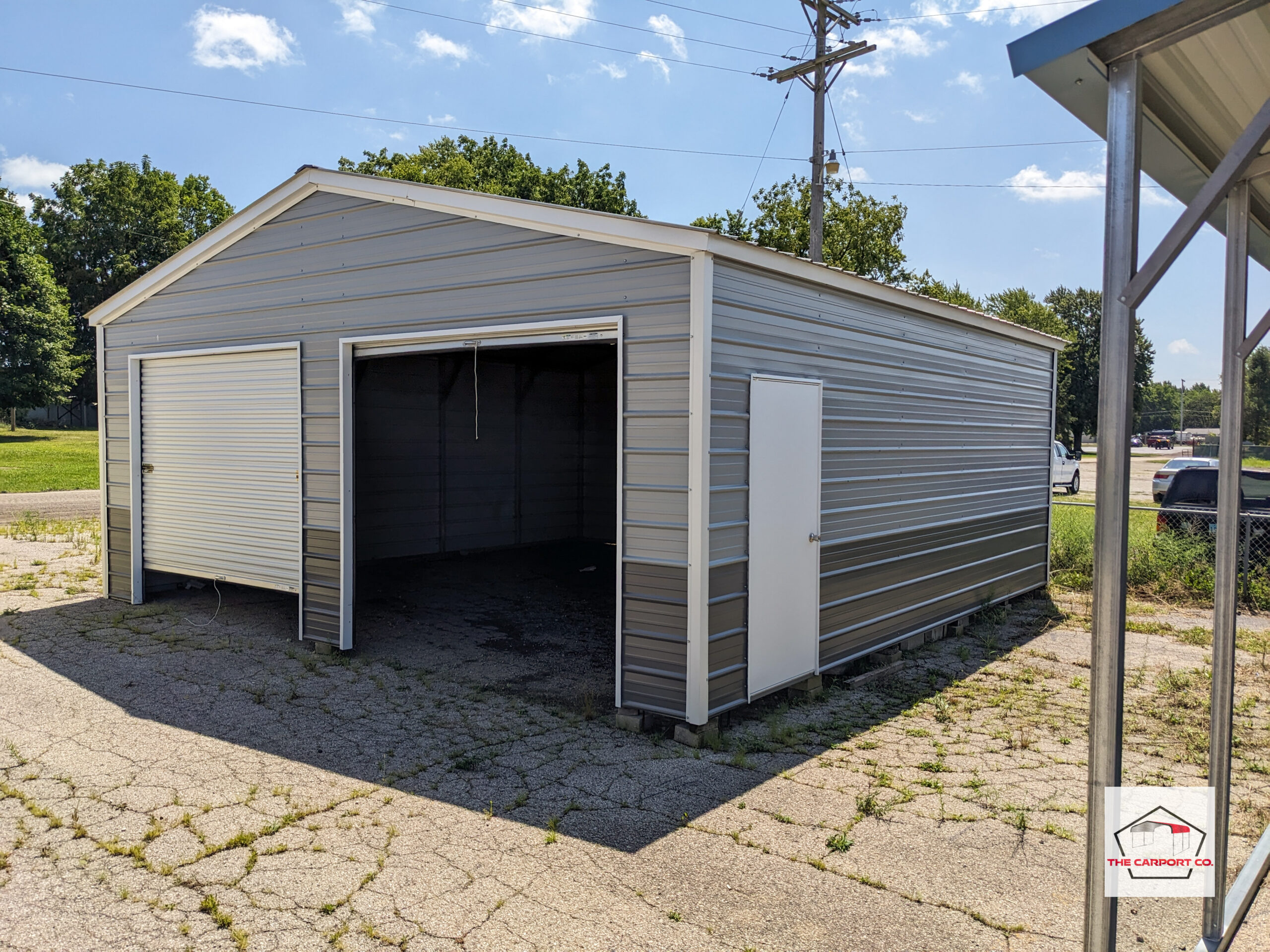 Blue with very dark gray wainscoting AKA two-tone addition, and white trim. The metal garage has horizontal siding, two 8x7 roll up doors on the front end, and a man door on the side.