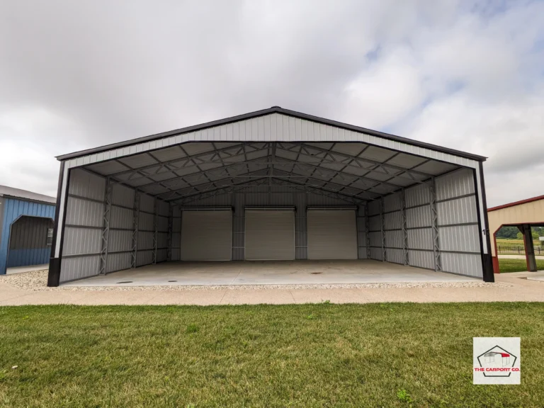 Interior of commercial metal wide span pre-engineered metal building (PEMB) with vertical siding and three 12x12 roll up doors.