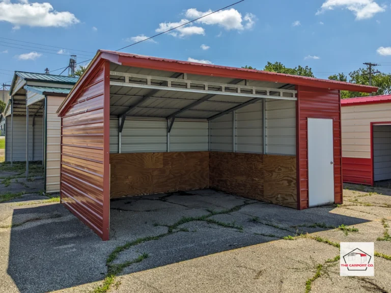 Corner of metal free standing lean to with an open section and a 4’ enclosed section that has a man door. This particular structure was done by The Carport Co. and used as a horse stall and mini storage structure. Horse feed was stored in the enclosed portion of it.