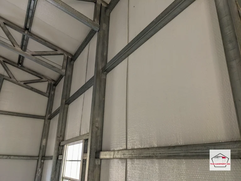 Close up of metal garage with vertical siding, commercial framing, and reflective foil insulation installed.