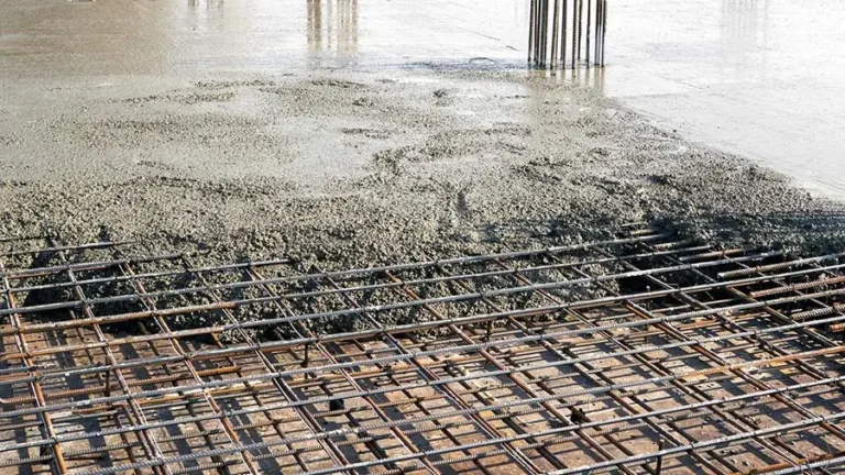 Rebar shown below wet concrete that is used to strengthen a buildings foundation and help to avoid collapse, cracking, and collapse.